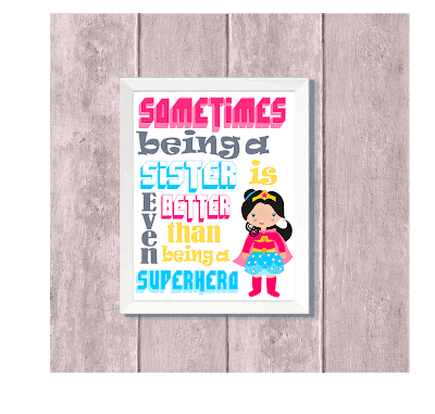 A kid's decoration picture in a white frame has a Wonder Woman-type hero in the lower right hand corner. Above, the text reads. "Sometimes being a sister is even better than being a superhero." 