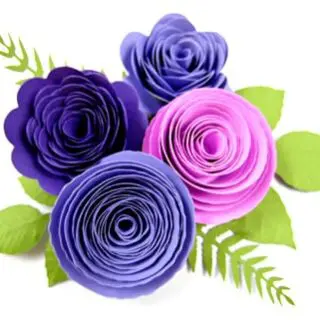 Blue and purple paper rosette flowers with green leaves.