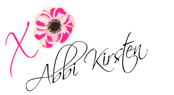 Abbi Kirsten signature in black text with a pink flower.