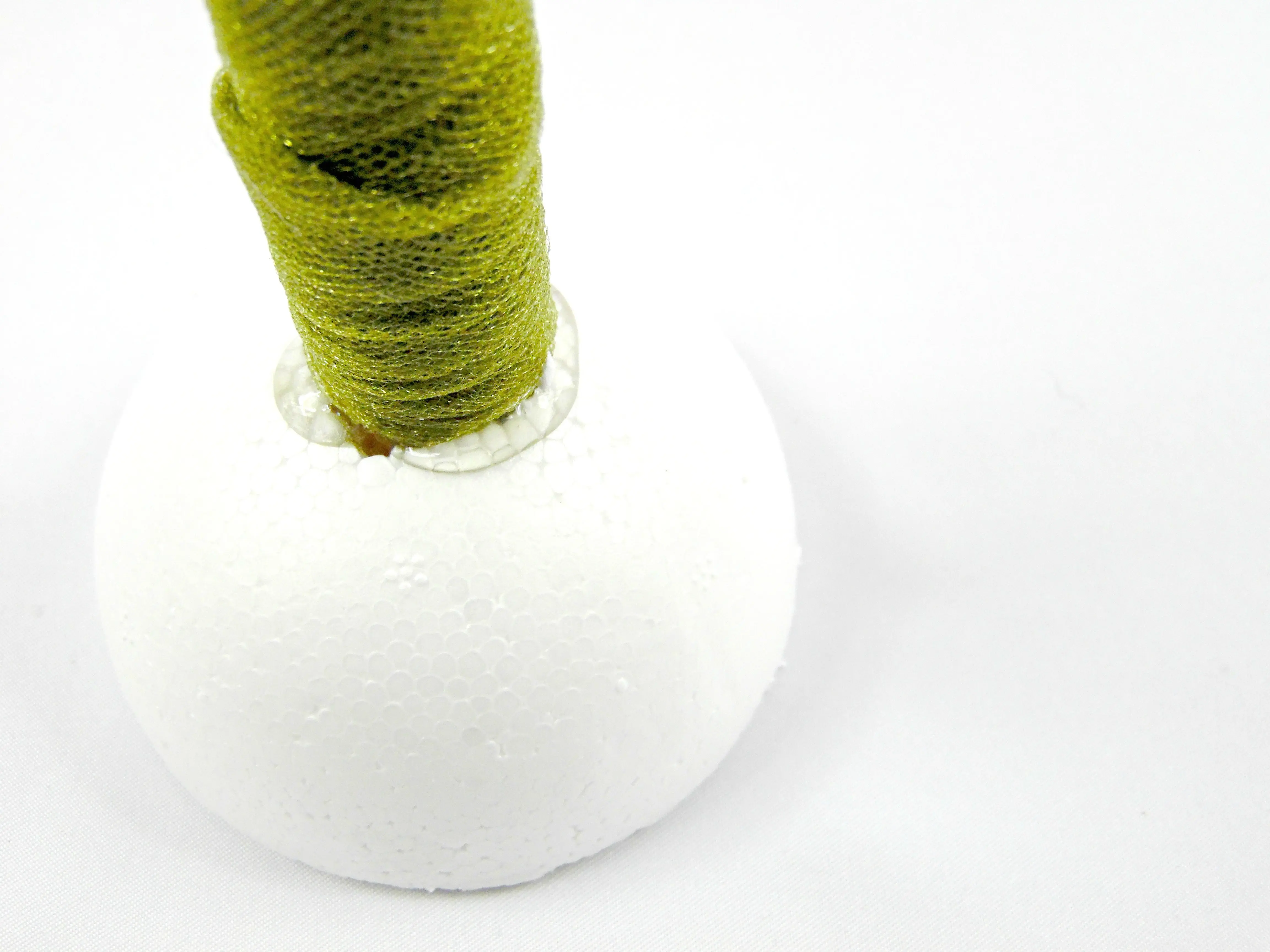 To attach the foam ball to the wooden dowel, you’ll need craft glue like hot glue.