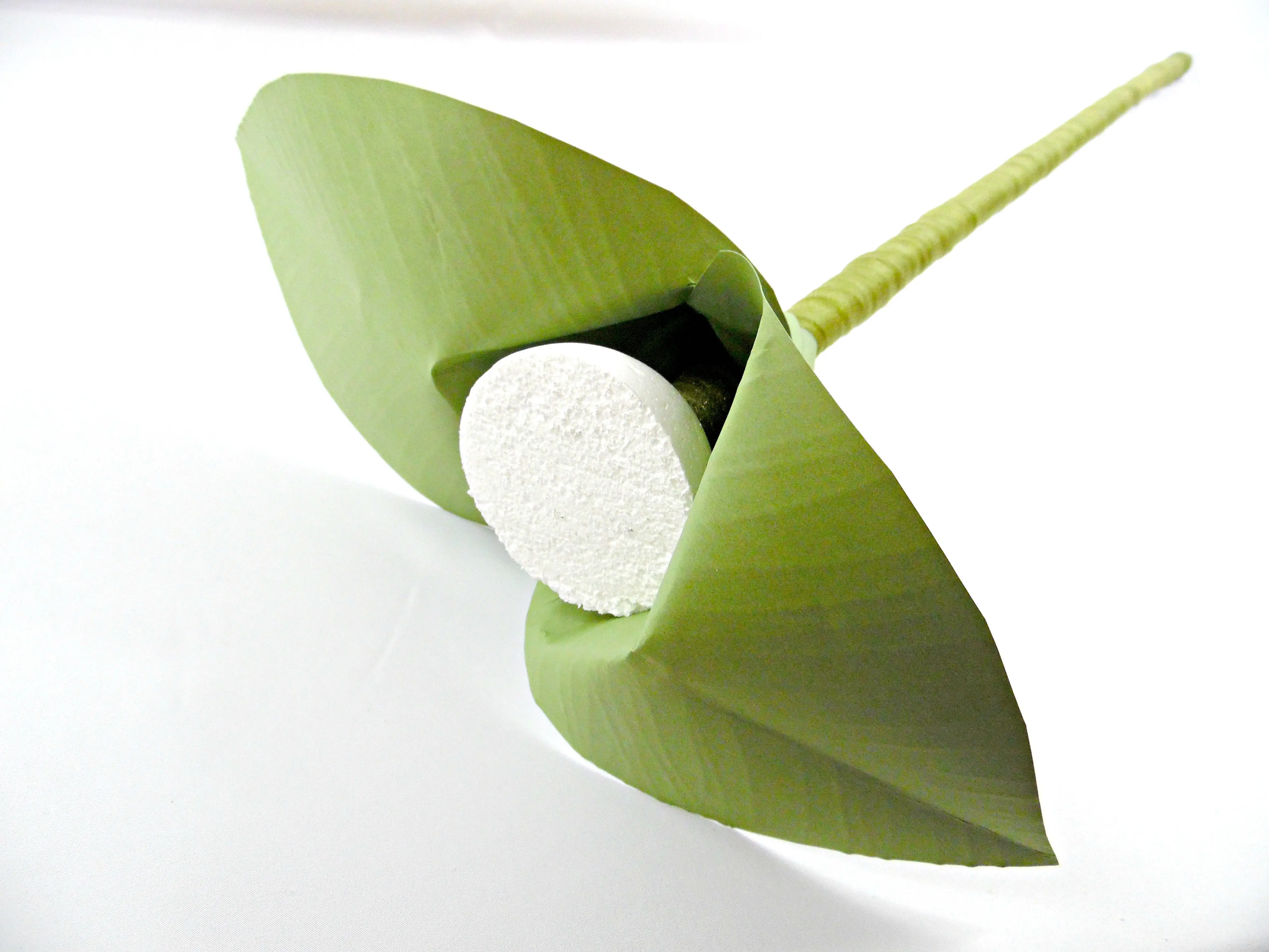 Two giant green paper flower leaves are attached to the giant paper flower stem. These paper leaves add extra support to the foam ball, the center of the giant paper flower.