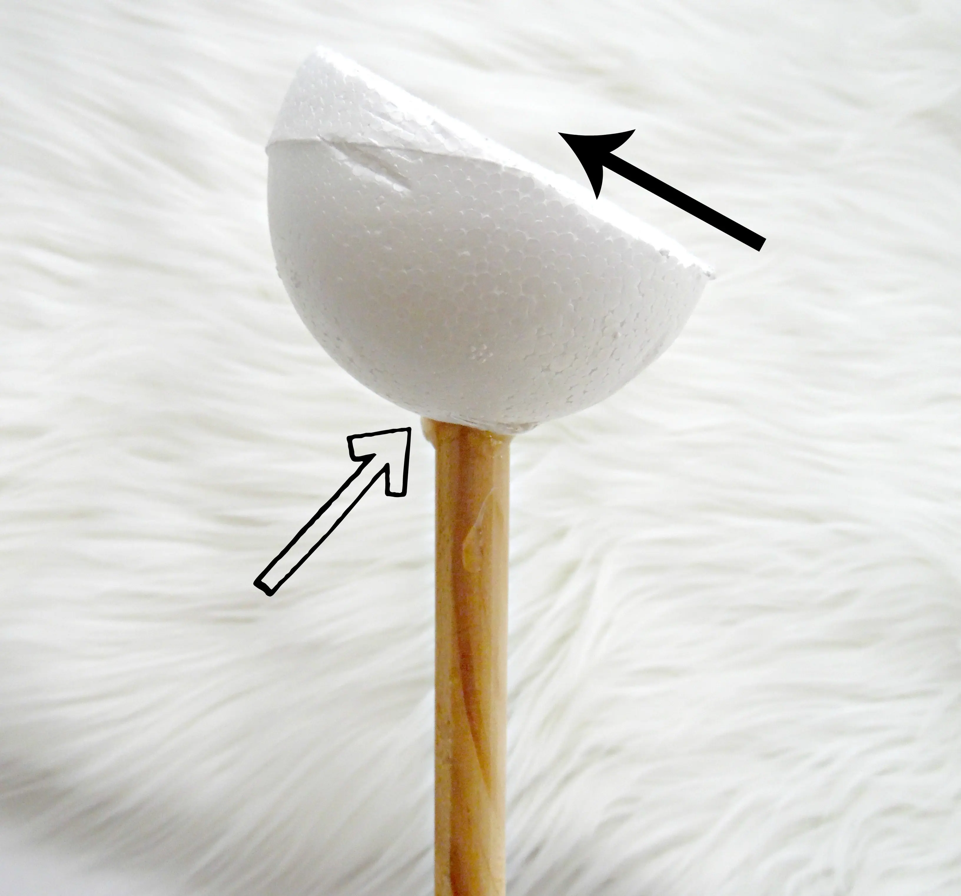 To create a giant paper flower stem for a more forward-facing flower, attach the foam ball to the wooden dowel stem at a 45-degree angle.