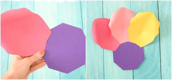 The left photo is a closeup of Abbi holding two large petals in pink and purple like playing cards. The photo on the right is a display of four petals in pink, salmon, yellow and purple. These petals are layered to create a large iris rainbow paper flower.