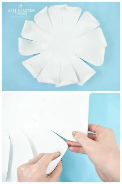 Abbi Kirsten adjusts the curled peony petals for the giant flowers first layer. A second image shows the peony's first petal layer from above.