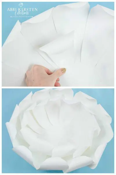 The upper image has Abbi Kirsten's hand holding down one petal from the second layer of the giant white peony paper flower. Below, and overhead view of the second layer of this enormous flower.