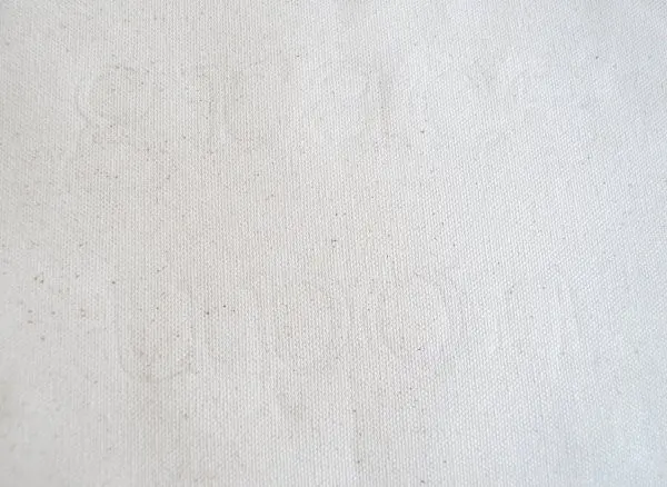 A faint outline that reads "grace upon" is barely visible on cream fabric.