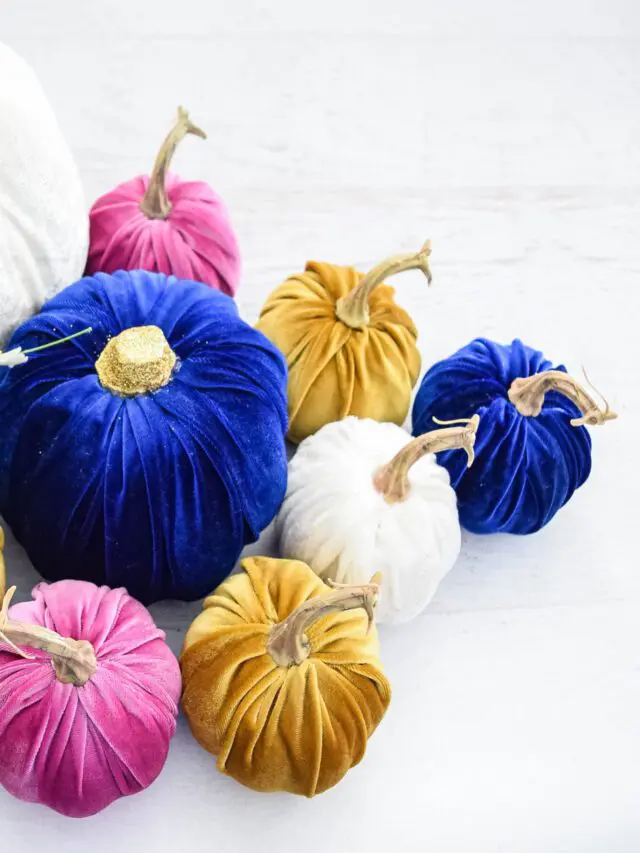 A collection of no-sew velvet pumpkins in different sizes, covered in white, blue, gold, and pink velvet.