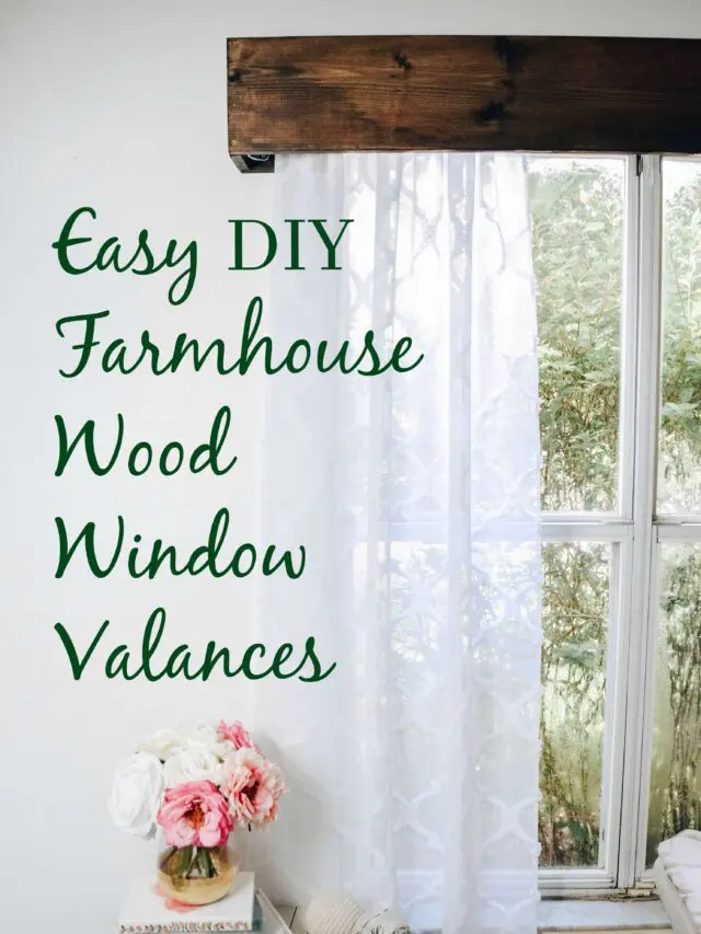 A partial shot of a window with wood valence and a sheer white curtain
