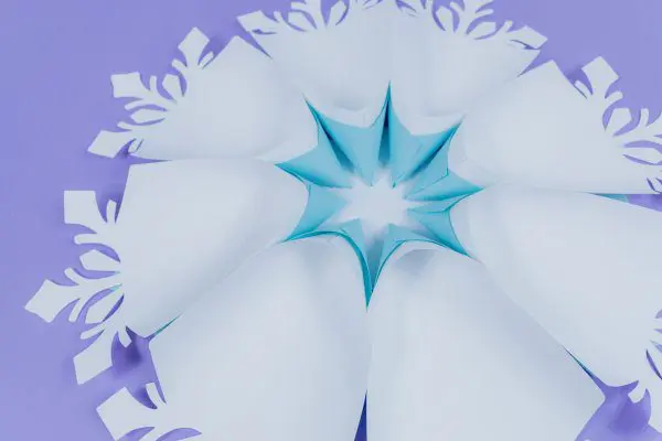 All 8 snowflake petals are glued to the base, completing the first layer of the giant paper snowflake.