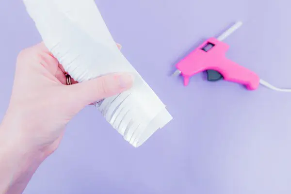 A single strip of fringed paper tacked down with glue to create a more "fluffy" fringe look.