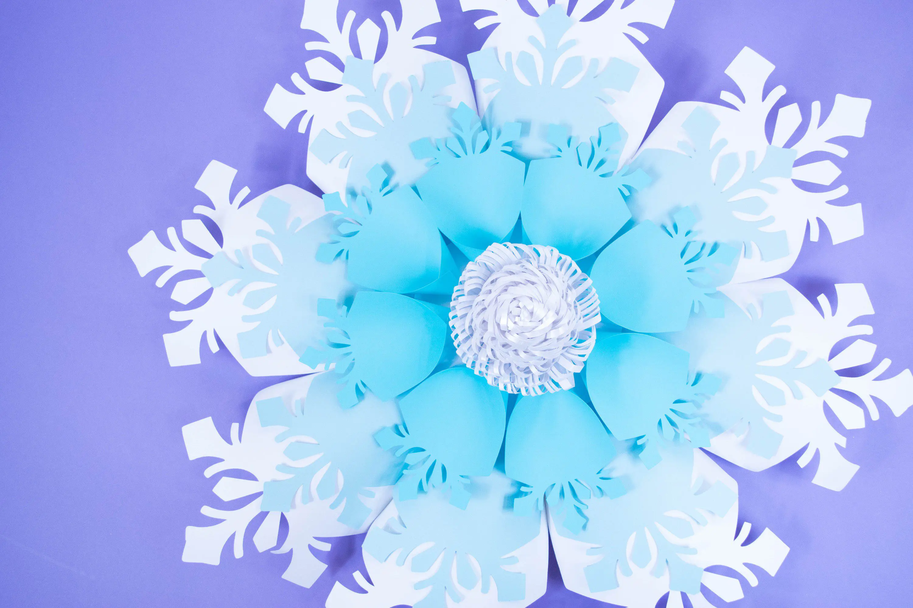 Create your own easy giant paper snowflakes with our paper snowflake tutorial and template. Deck your halls for Christmas with these big paper snowflakes.