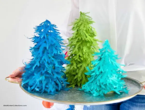 Three small paper Christmas trees made with green and blue paper.