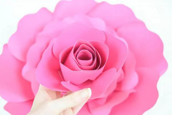 The Penelope rose center is about to be glued into the full, layered pink paper rose underneath it.