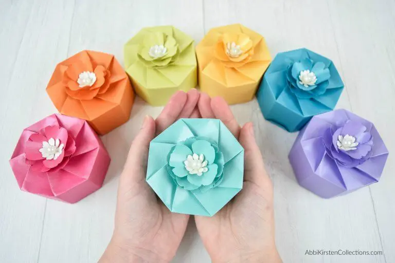 hands holding a light blue paper box