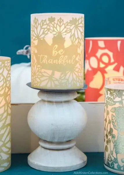 LED pillar candles decorated with fall candle wraps of gold, orange and metallic blue make great decorations for any Autumn gathering. 