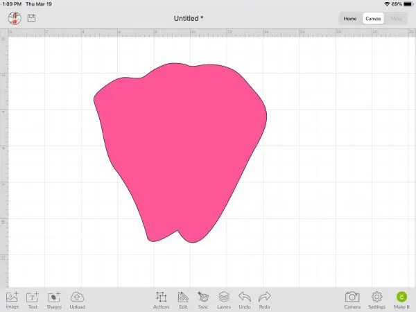 The once empty Cricut Design Space canvas now has a large pink petal template in it, having been uploaded and inserted from a zipped file.