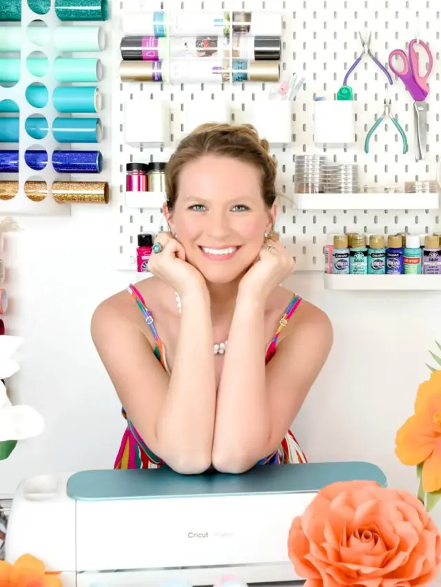Abbi Kirsten smiling while leaning on a Cricut machine