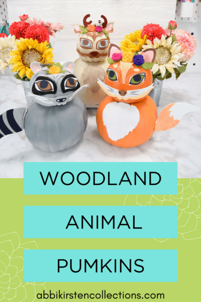 Text on a blue and green rectangle says "Woodland Animal Pumpkins Abbikirstencollections.com". These no carve pumpkins have been turned into a felt and vinyl gray raccoon, orange fox, and light brown deer.