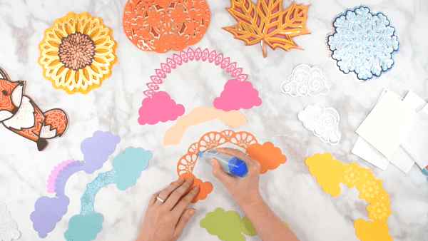 All the cut pieces for the 3D rainbow mandala are laid out and ready to be assembled using glue and foam tabs
