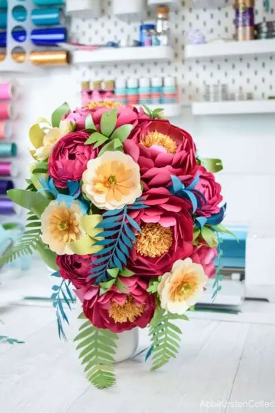 A colorful, completed flower bouquet sits finished in a small vase.