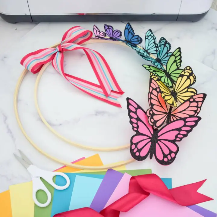 A colorful paper butterfly wreath made with cardstock butterflies.