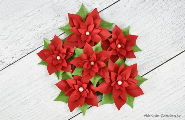 Small poinsettia paper flowers. Download poinsettia flower templates to create an easy paper craft for your Christmas holiday decor.