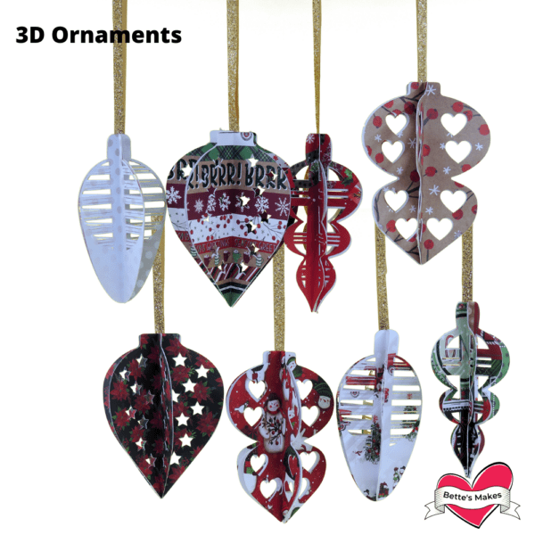 Numerous red, green, white, tan and black paper 3D Christmas ornaments hanging from golden ribbon.  