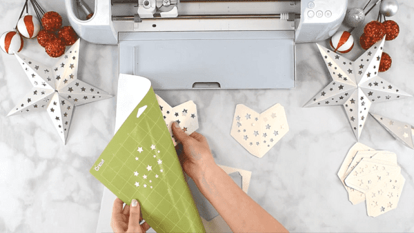 Abbi cutting star templates with Cricut.