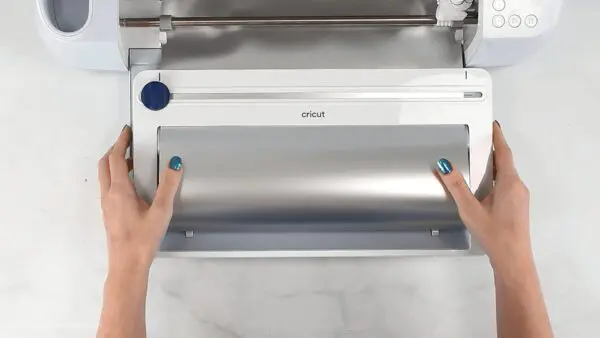 Cutting vinyl for ornaments with Cricut. 