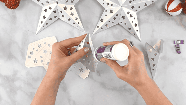 Abbi glueing pieces of the paper star template.