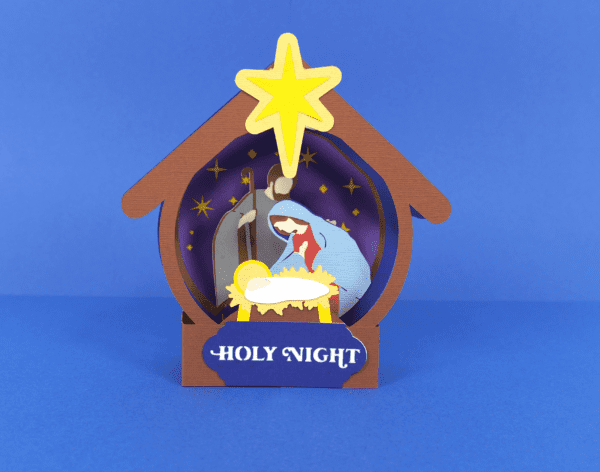 Nativity scene pop up card for Christmas handmade with cardstock. Card is shown on a navy blue background. 