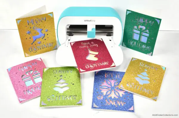 Learn how to make Christmas cards with your Cricut machine. Featuring the Cricut Joy machine use the card mat to make quick easy Christmas cards.