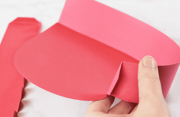 The sides being attached to a dark pink paper heart box.
