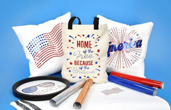 Faux rhinestones with holographic iron-on vinyl decorate pillows, tote bags and framed art. Also pictures are holographic vinyl rolls all on a blue background.