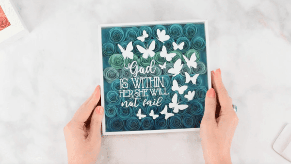 Blue ombre paper flower shadow box assembly.