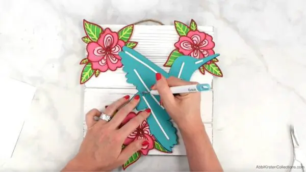 Adding a paper mandala to a white wood sign. 