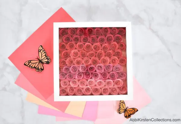 Pink ombre rolled paper flowers for a shadow box.