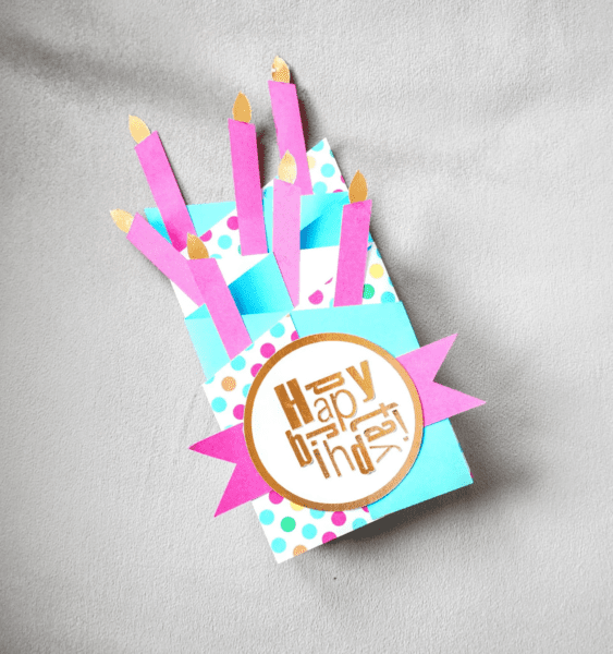 a layered card in blues and pinks with candles and happy birthday text