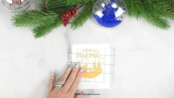 Transfer tape being applied to gold vinyl 