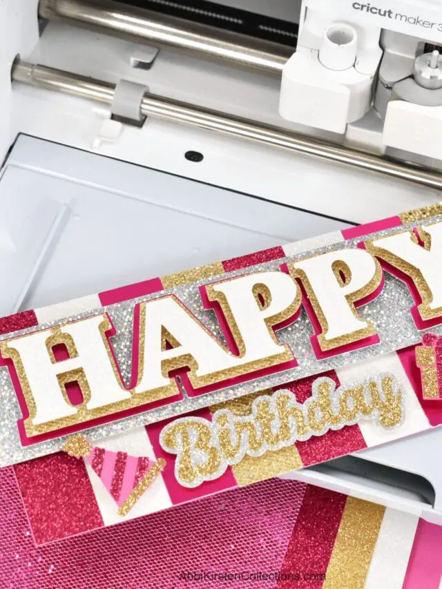The image shows a pink and gold happy birthday card made with a Cricut machine. Learn how to make cards with Cricut.