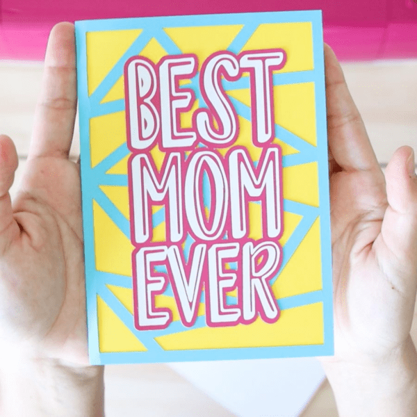 The image shows a card in blue and yellow that says, best mom ever. Get the free SVG file
