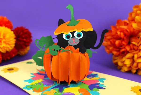 Pop up pumpkin card with a black cat made from cardstock paper with Cricut.