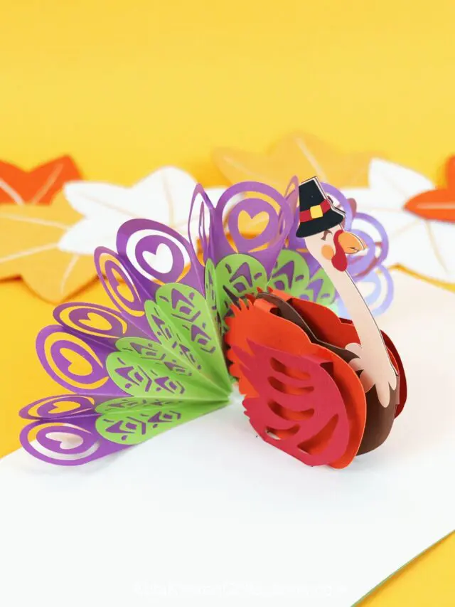 Cardstock turkey pop up card on a yellow background.