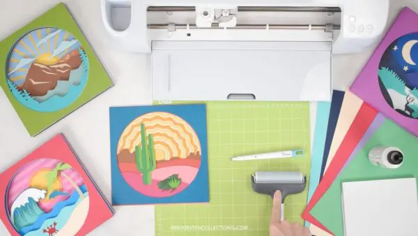 Supplies on a craft desk to make paper shadow boxes