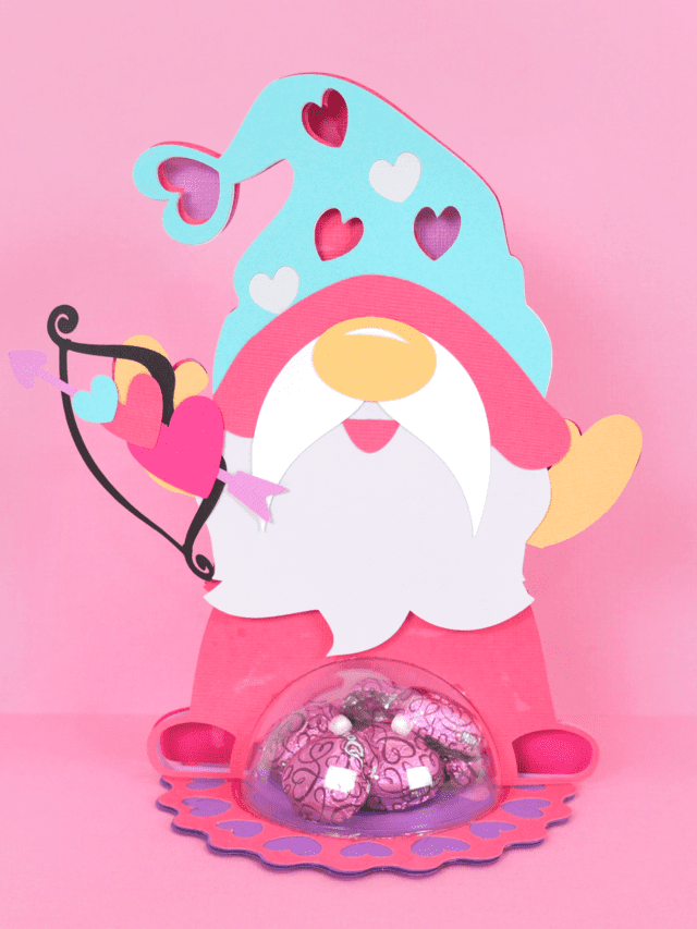 Cute gnome candy holder made from paper with a plastic dome to hold the candy.