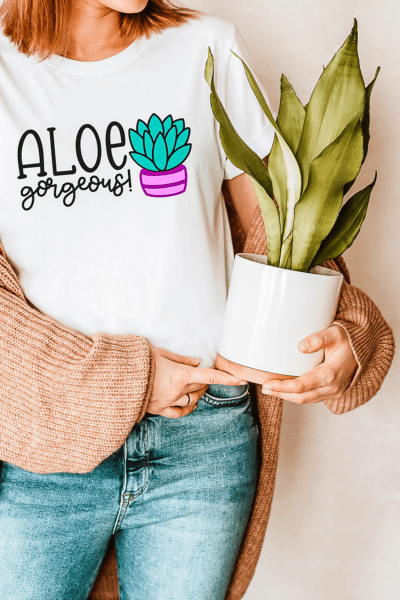 Woman holding a potted aloe plant and wearing a t-shirt with text Aloe gorgeous! Download this free SVG cut file for your cutting machine