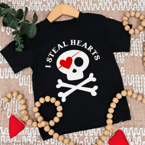 Black t-shirt with skull and crossbones and heart eyepatch with text I Steal Hearts.