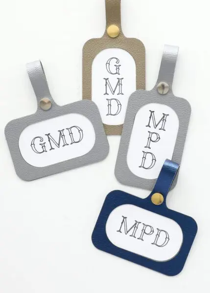 Free SVG files for Cricut: four luggage tags with initials on each one.