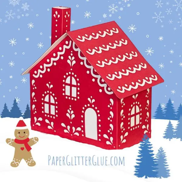 Red and white paper gingerbread house on snow with gingerbread man, blue pine trees and snowflake sky.