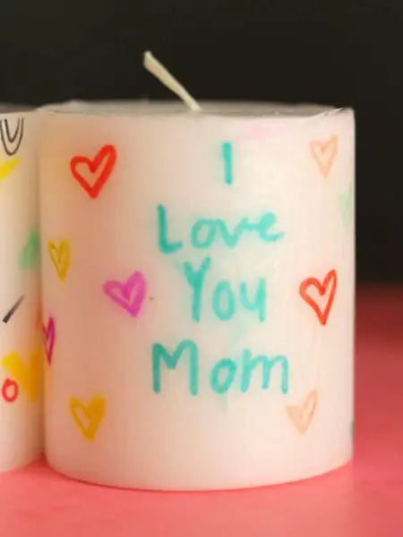 Candle with decorated hearts and text I love you Mom
